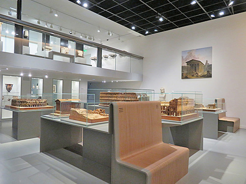 Fig. 5. View of the Legacy of Roman Antiquity gallery with architectural models by Auguste Pelet, and Medieval Period mezzanine above. Musée de la Romanité, Nîmes.