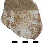 Fig. 7. Fragment (3055–13a) of thick white plaster decorated with a dark band, perhaps brown or black, possibly a fragment from a painted floor, from area D-South.