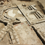 Fig. 4. Islamic Jarash Project. Entrance area to bathhouse and latrine in foreground, showing semicircular latrine and two basins in background.