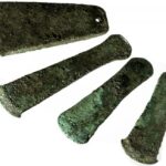 Fig. 26. The four copper axes retrieved in a cachette in Pillared Hall (L.1040) in Palace B at Khirbet al-Batrawy (Zarqa) (L. Nigro).