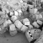 Fig. 18. Collapsed archway of the gate of the Late Roman fort at 'Ayn Gharandal, with in situ inscription block (facedown) at lower right (courtesy 'Ayn Gharandal Archaeological Project).