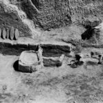 Fig. 4. The Bakery in Southwest House, facing north with the grindstones displayed against the scarp. From west to east are the kneading trough, storage bin, and two ovens (courtesy Penn Museum, Gordion Project Archives, image no. GR 66-10).