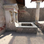 Fig. 1. Aedicular fountain, water basin, marble channel, and southern bench of the water triclinium in the Casa dell’Efebo, facing west.