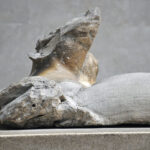 Fig. 5. East pediment A (Helios), detail. Hole for attachment of bronze object (a fish or dolphin?), on front edge of sea mass behind Helios’ right shoulder. London, British Museum.