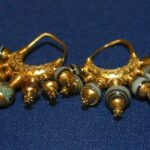 Fig. 3. Pair of earrings with pomegranate pendants, gold with beads of agate and other stone, wdth. ca. 4 cm. Tomb II, Northwest Palace, Nimrud. ND 1989.38a, b; Baghdad, Iraq Museum, inv. nos. 105821, 105822 (N.L. Feeney, 318th Public Affairs Operation Center [PAOC], U.S. Army, Baghdad 2003).