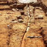 Fig. 13. Phase 4 plaster floor with clay channel west of Unit E. View from the west.