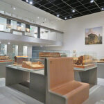 Fig. 5. View of the Legacy of Roman Antiquity gallery with architectural models by Auguste Pelet, and Medieval Period mezzanine above. Musée de la Romanité, Nîmes.