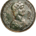 Fig. 19. Contorniate, obverse, with a bust of Trajan and an incuse monogram alongside, probably P ET L for palma et laurus (the palm and the laurel); mid fourth to early fifth century CE (scale: 2 cm; courtesy Münzsammlung des Instituts für Klassische Archäologie der Universität Tübingen).