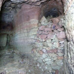 Fig. 17. The rubble-blocked entrance of Grotto 4 (at right) with the entrance to Grotto 5 (at left), looking southwest (R.B. Gorham).