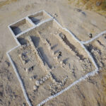 Fig. 13. Aerial view of the pillared buildings abutting the Level V city wall in Area BC (cf. this article’s print fig. 22). White sandbags secure the balks.