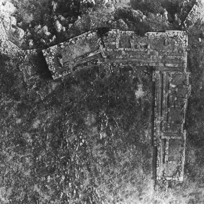 Aerial view of the Melathron; the arrow points to the triangular gap between the fortification wall and the Melathron filled with Cyclopean masonry (Iakovidis 1989, pl. 37; © The Archaeological Society at Athens).